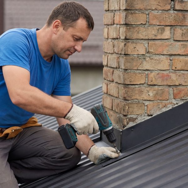 man repairing roof flashing